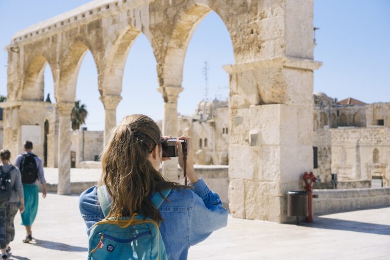 Woman Taking Pictures of Ruins