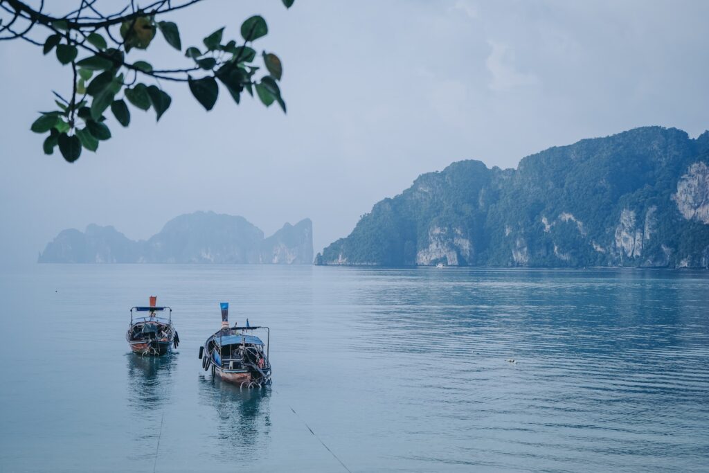 boat on water near mountain during daytime