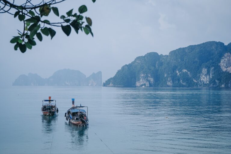 boat on water near mountain during daytime